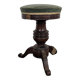 Green velvet piano stool with a turned leg.
