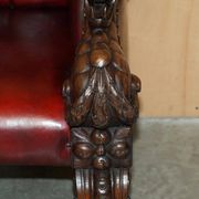 Victorian Chesterfield leather sofa with carved lion heads.
