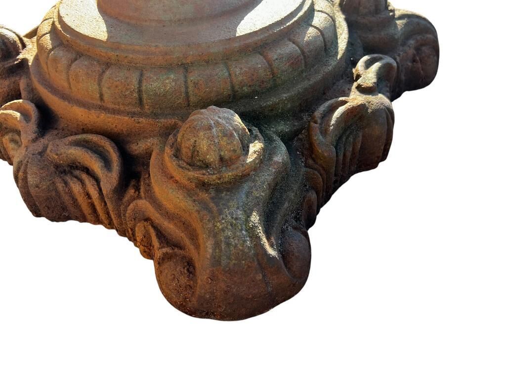 Antique cast iron garden table with decorative openwork top.