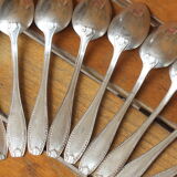 15 small silver metal spoons with rows of beads