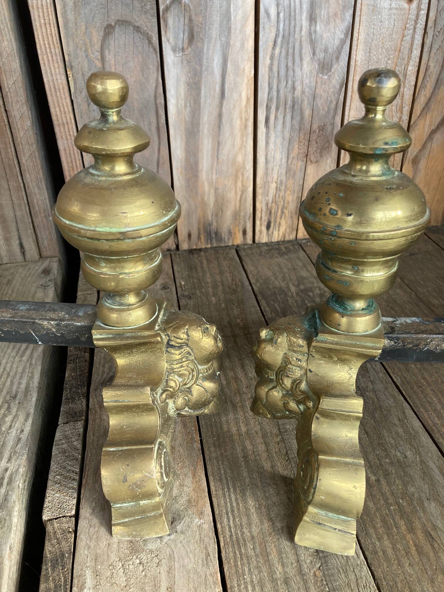 Pair of andirons and grates in cast iron and bronze with gilded grotesques, 17th century