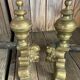 Pair of andirons and grates in cast iron and bronze with gilded grotesques, 17th century