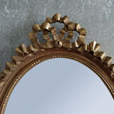 Oval mirror in carved and gilded wood in Louis XVI style