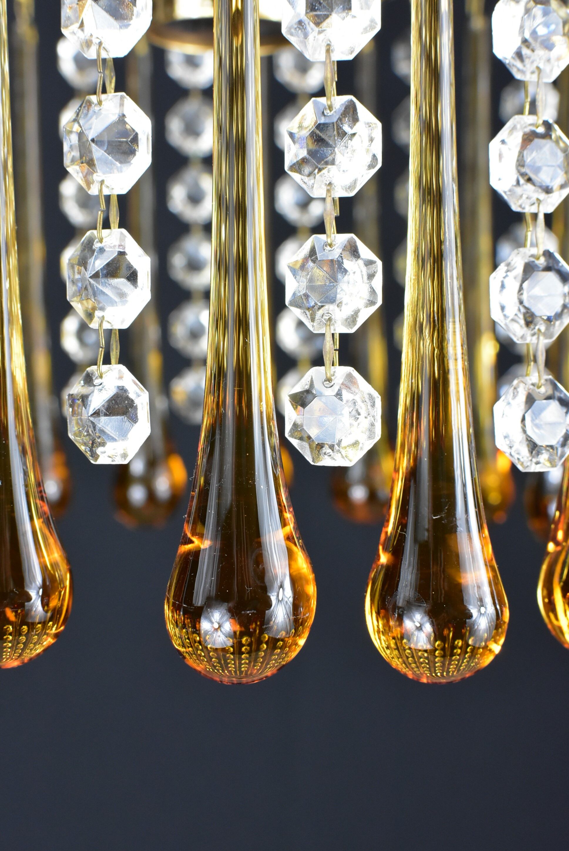 Suspension with tassels drops of water an glass