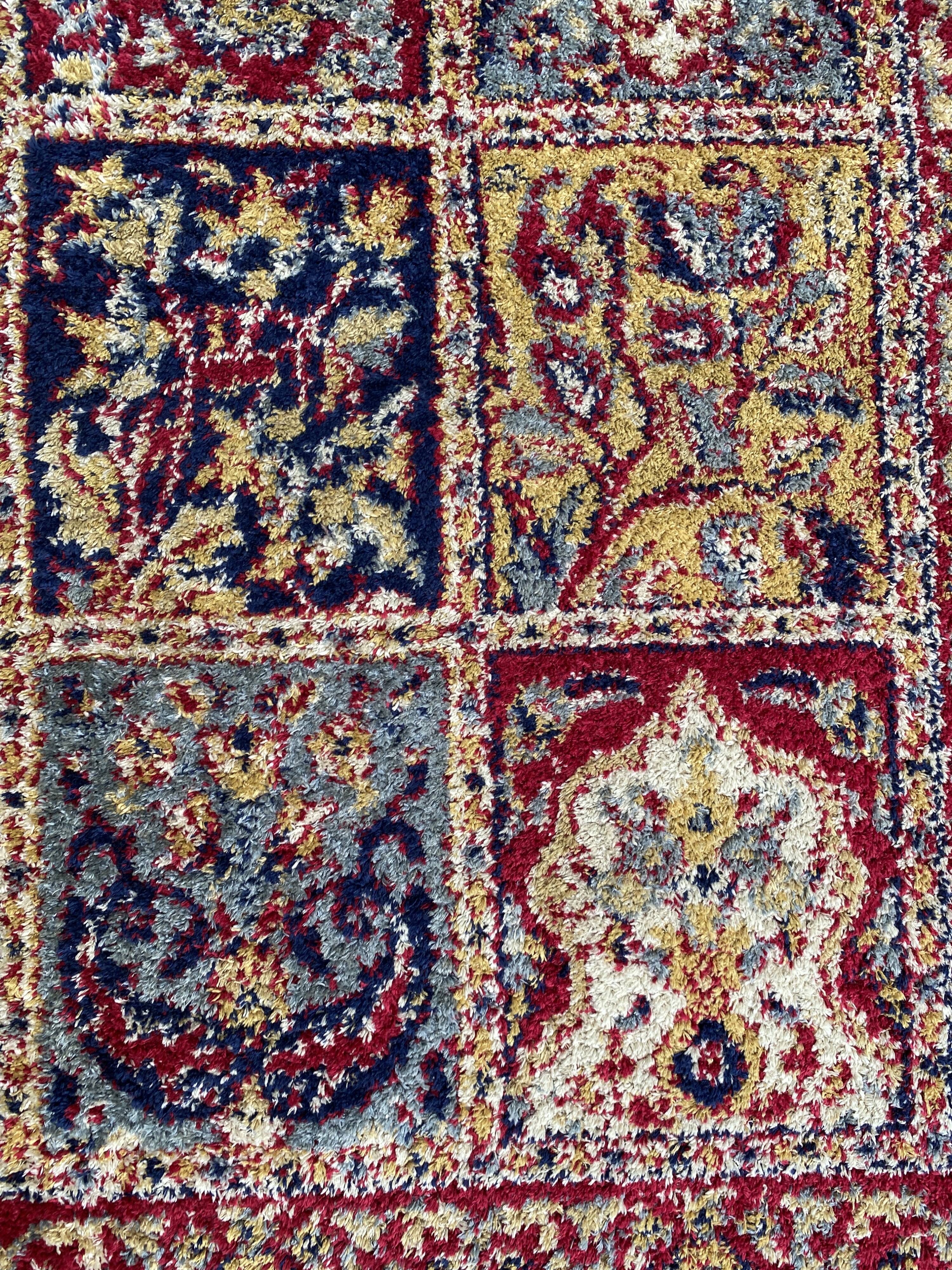 Vintage mechanical Turkish rug with box decoration on a red and navy blue background 139 x 68 cm