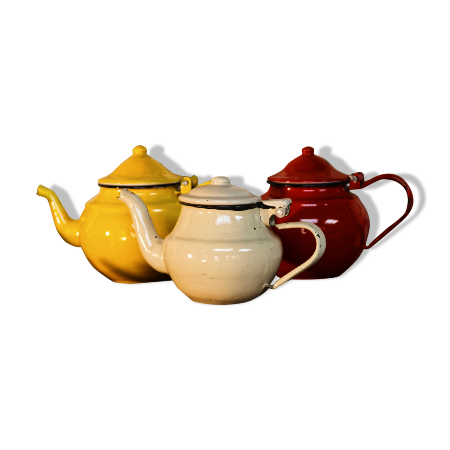 Trio of small enamelled teapots