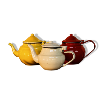 Trio of small enamelled teapots