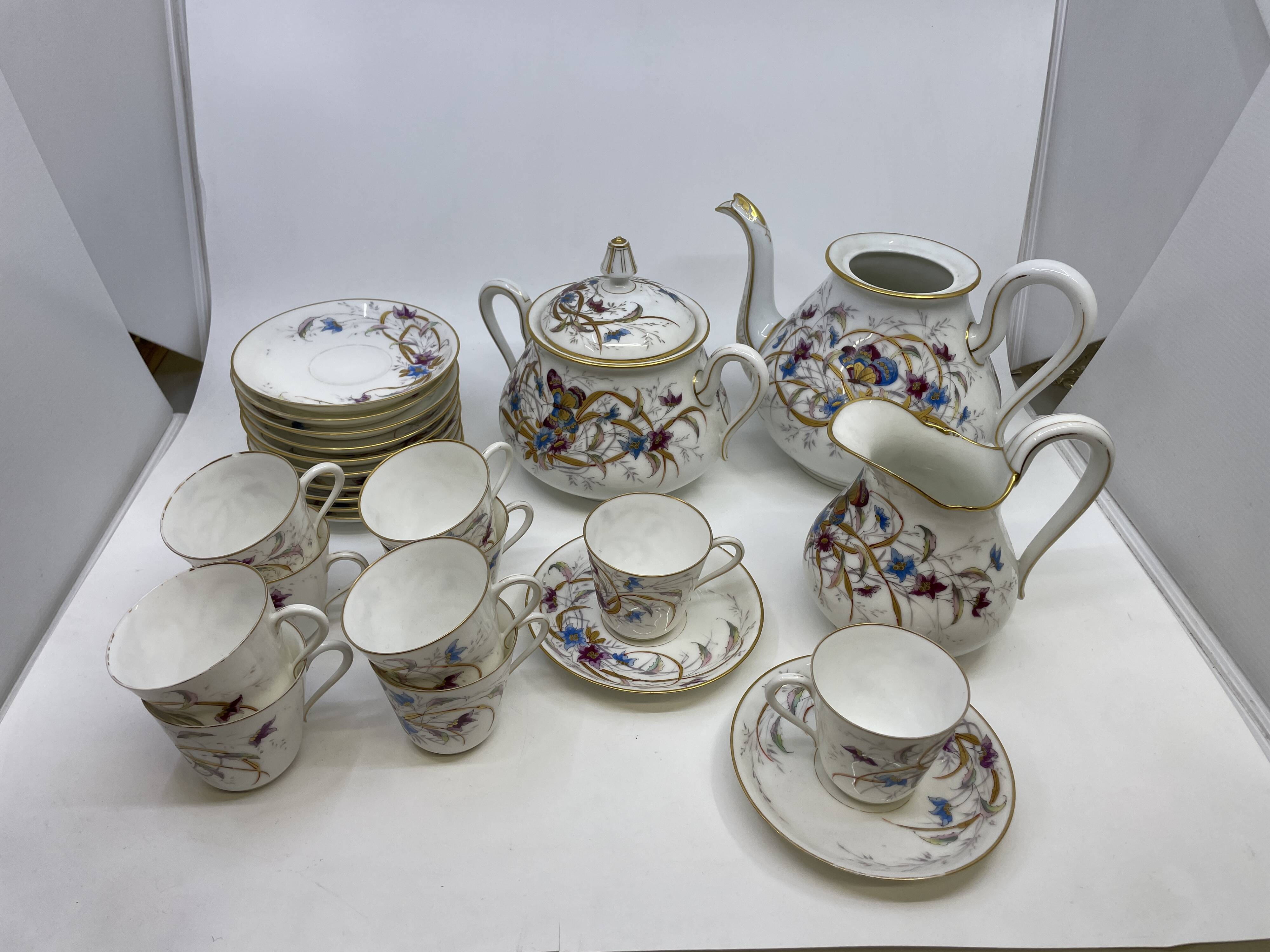 Porcelain tea service with floral and butterfly decorations, 25 pieces.