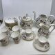 Porcelain tea service with floral and butterfly decorations, 25 pieces.