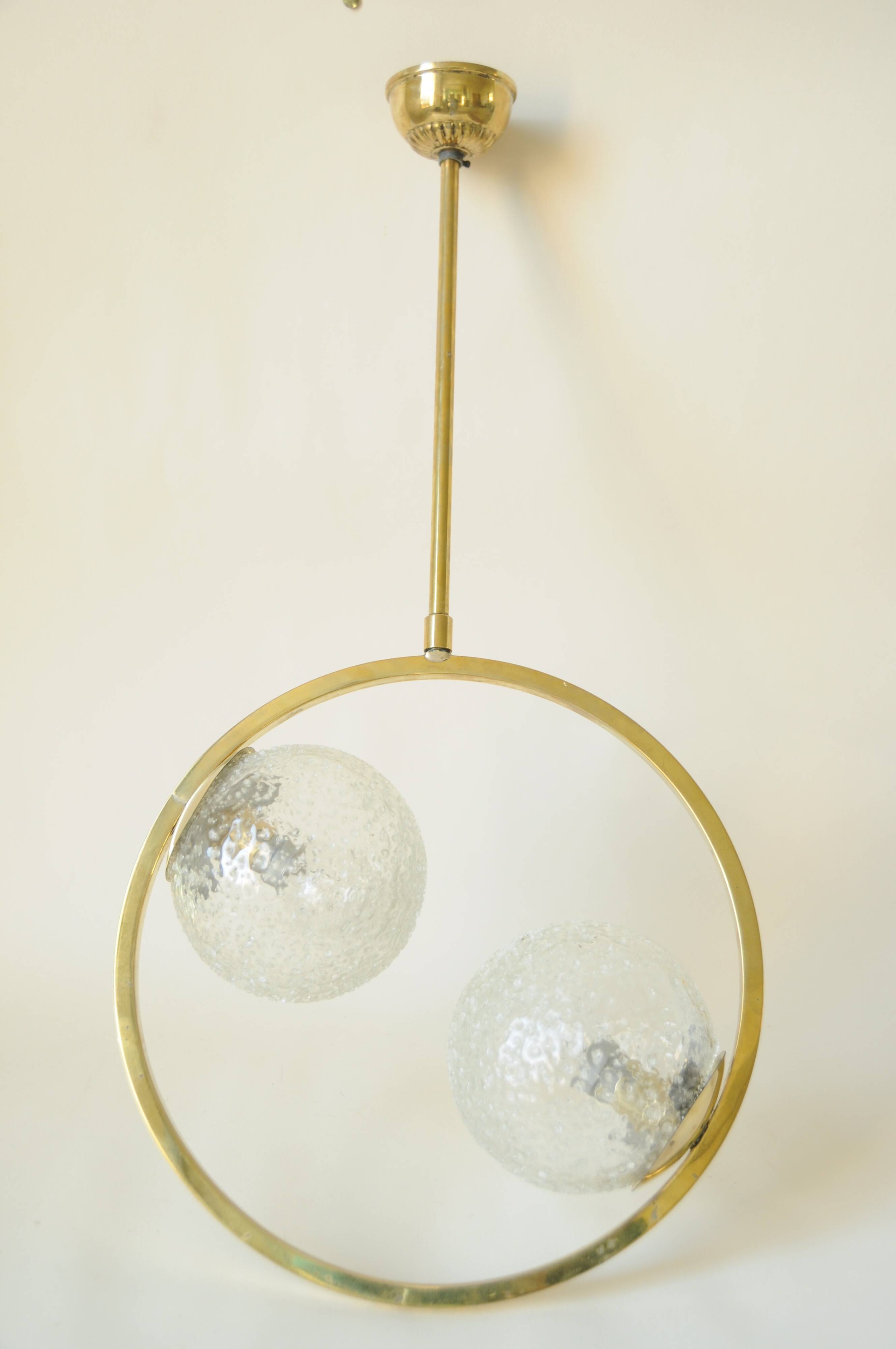Mid century modernist pendant light in brass and textured glass ball