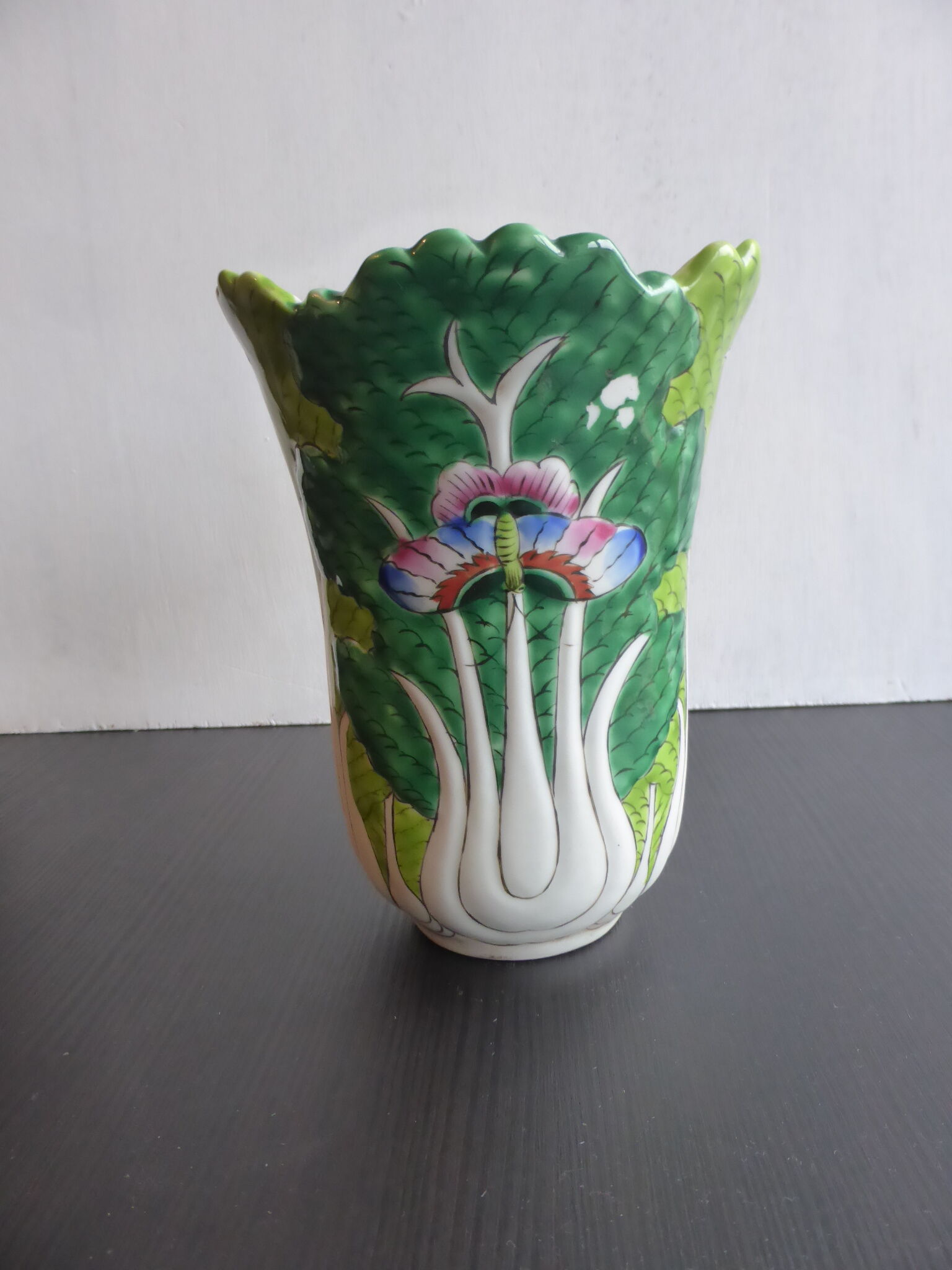 Ancient Asian ceramic vase green and white background decorated with butterflies