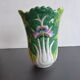 Ancient Asian ceramic vase green and white background decorated with butterflies