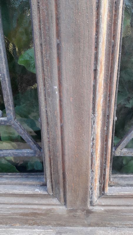 Oak entrance door and its frame and transom, wrought iron gates