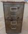 Vintage industrial metal furniture with a rusty effect, featuring two drawers on wheels.