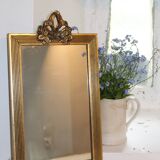 Small rectangular mirror in gilded wood with a pediment decorated with flowers