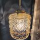 Moulded glass lamp with a cubic-spherical relief design.