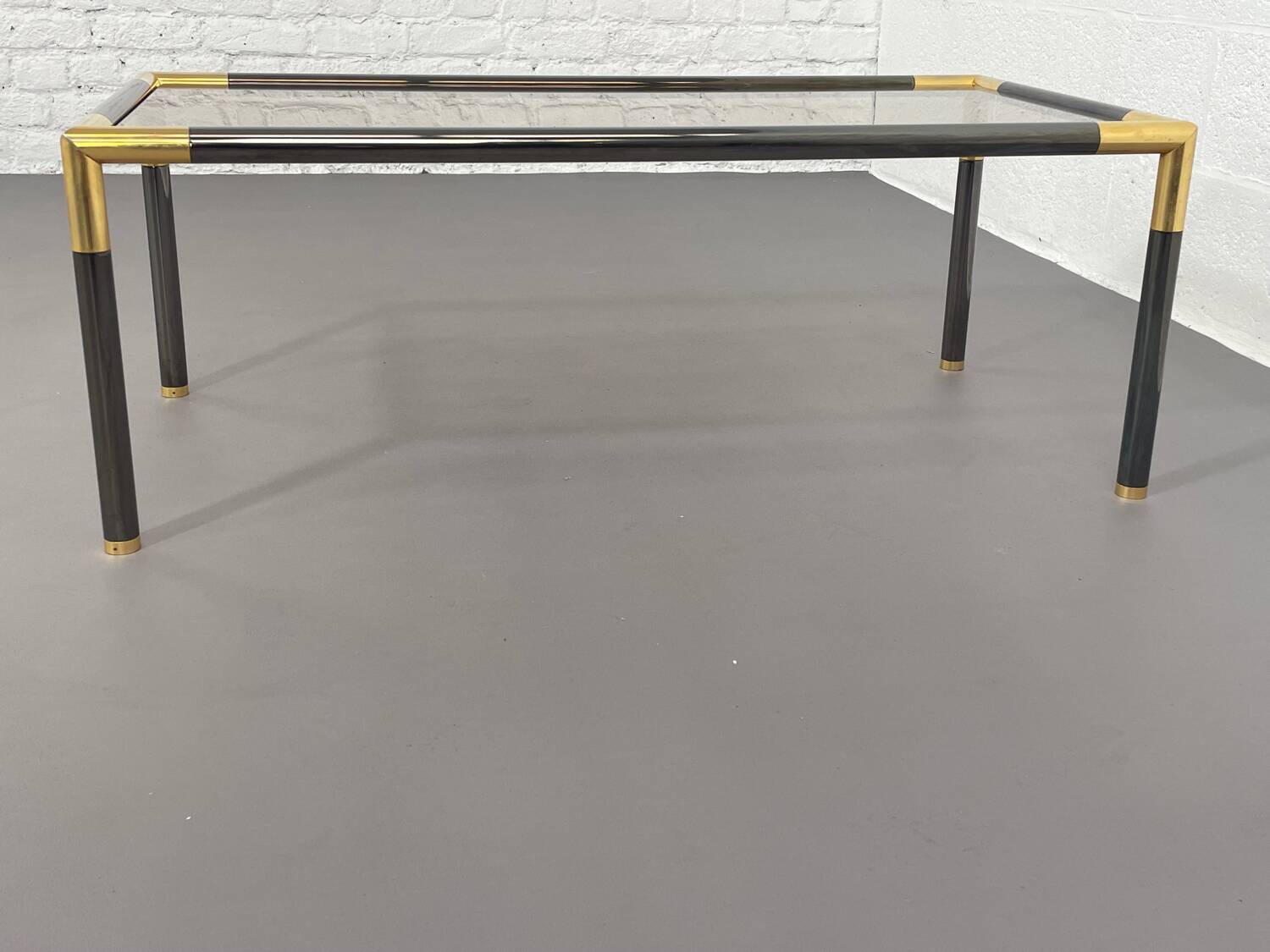 Gunmetal gold metal and smoked glass coffee table from the 70s