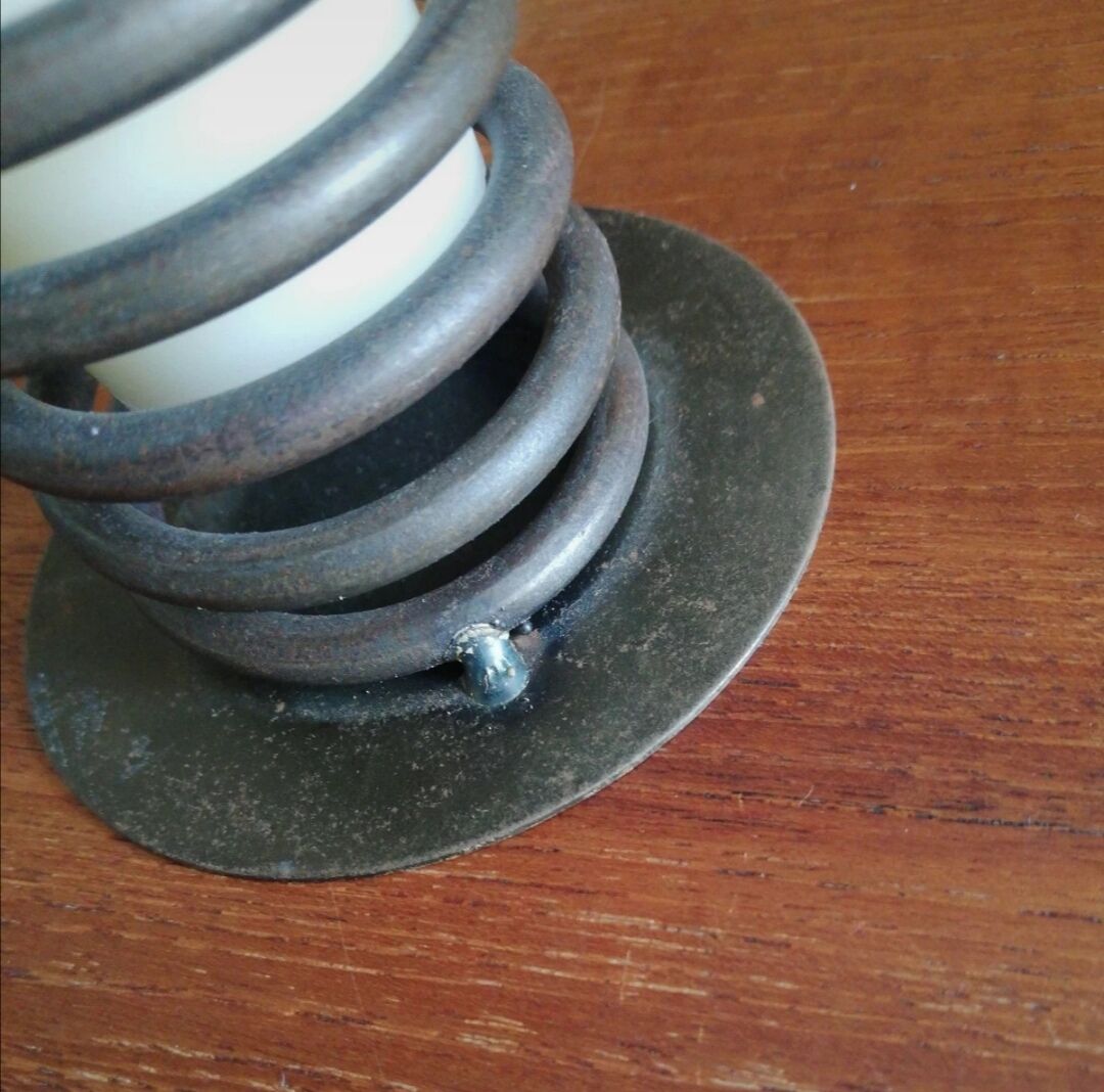 Spiral metal candle holder spring with candle, bronze appearance