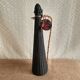 Glass bottle covered with black scoubidou with twisted golden handle - vintage