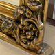 French palace mirror with bow and lion heads, gilded frame.