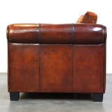 Canapé en cuir de mouton 2,5 places, luxueux et confortable, avec des coussins en tissu.