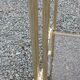 Pair of Hollywood Regency side tables in gold metal and smoked glass.
