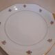Hexagonal plate Lamotte with a double gold border, decorated with small bouquets.