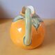 Orange pitcher in slip
