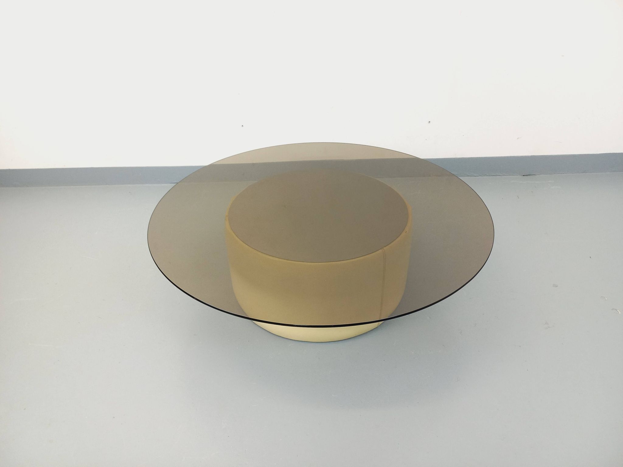 Vintage round coffee table in glass, leather, and metal in Space Age style from the 70s.