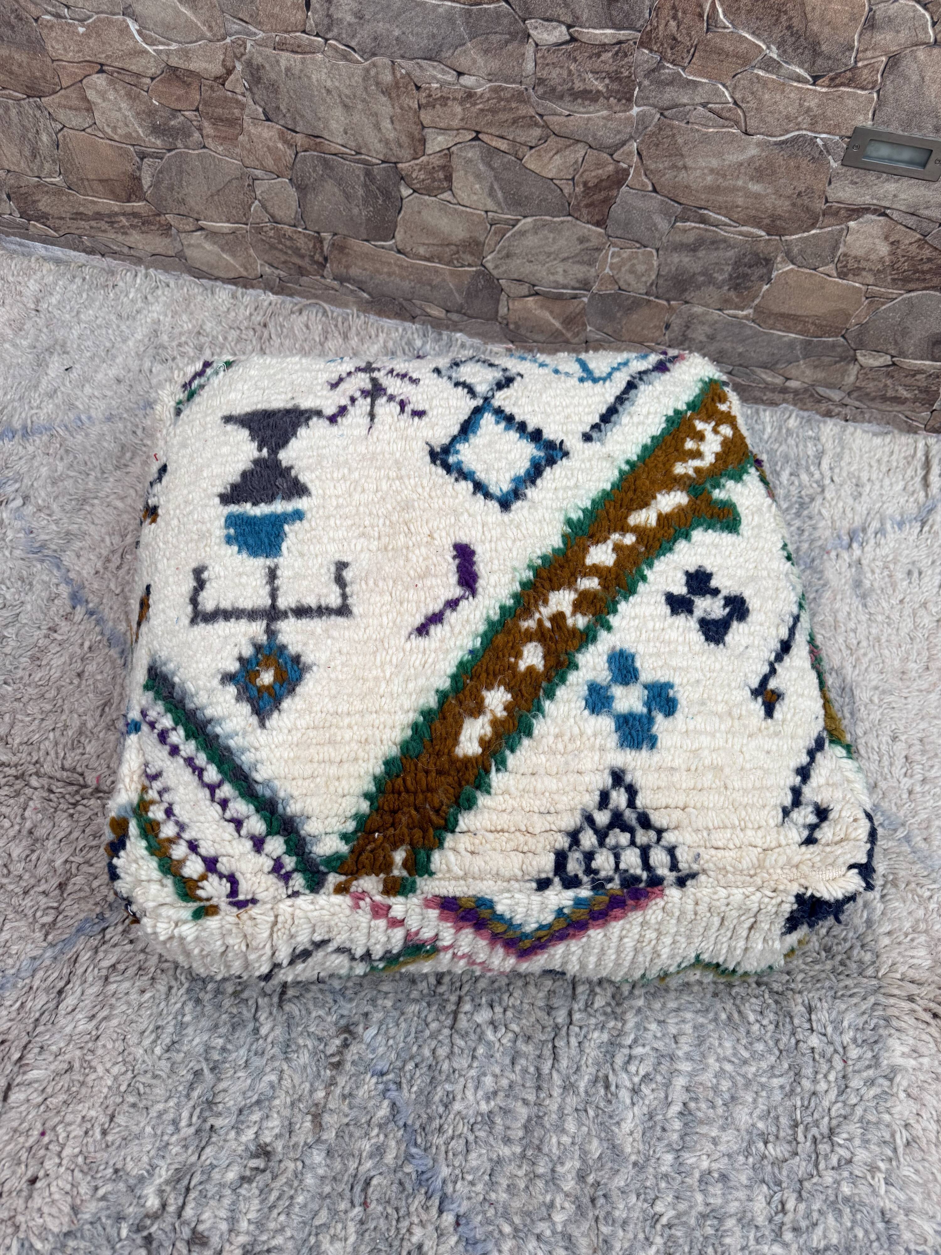 Berber floor pouf: Handwoven Moroccan wool cushion.