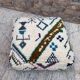 Berber floor pouf: Handwoven Moroccan wool cushion.