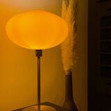 Table lamp with a vintage orange glass globe saucer and a gold base