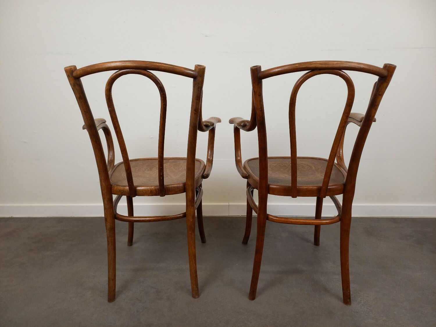 Pair of curved wooden bistro armchairs