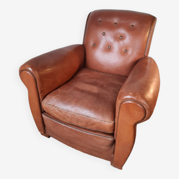 Old leather club armchair, circa 1940 art deco style