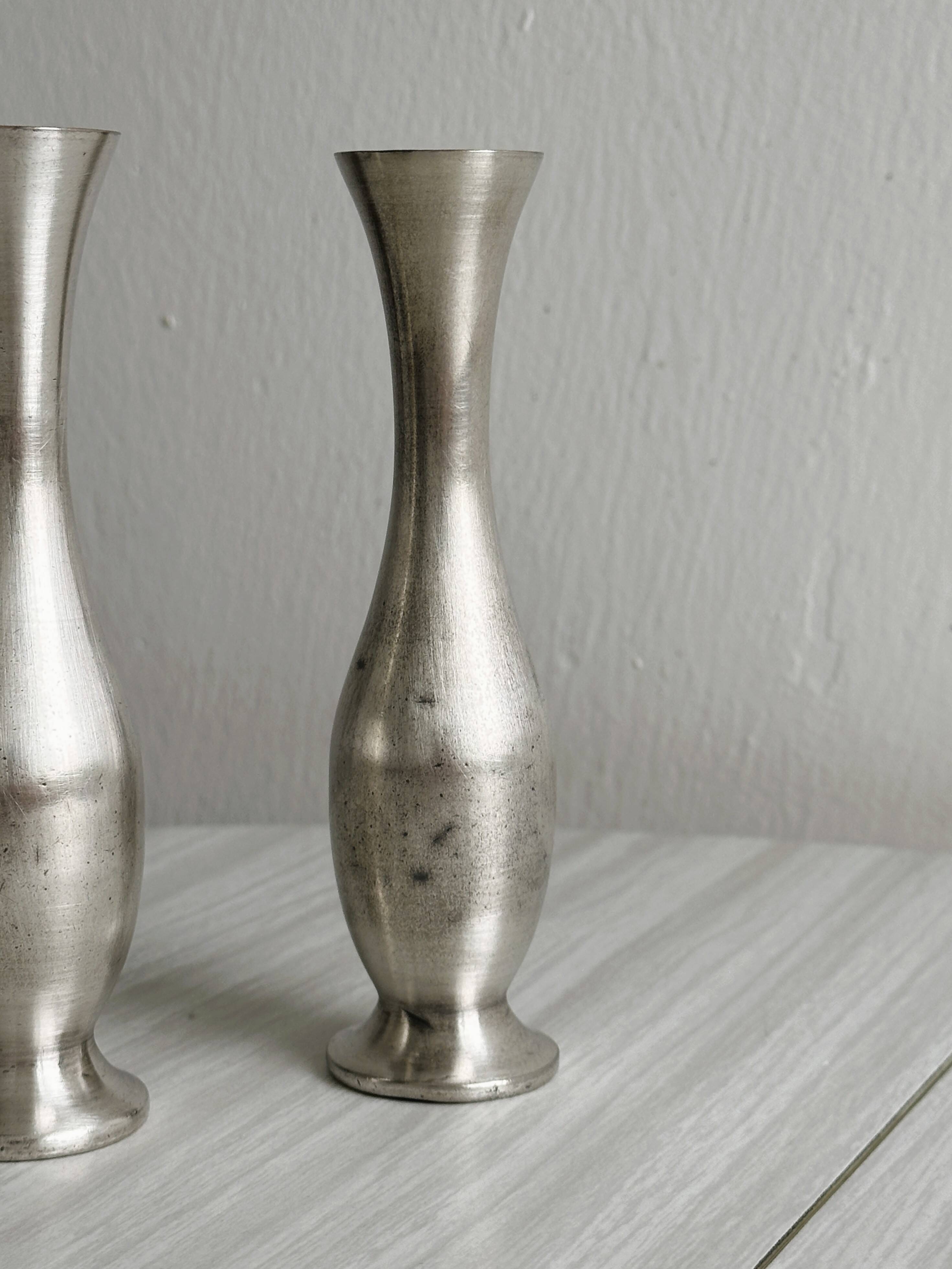 2 shiny metal vases
