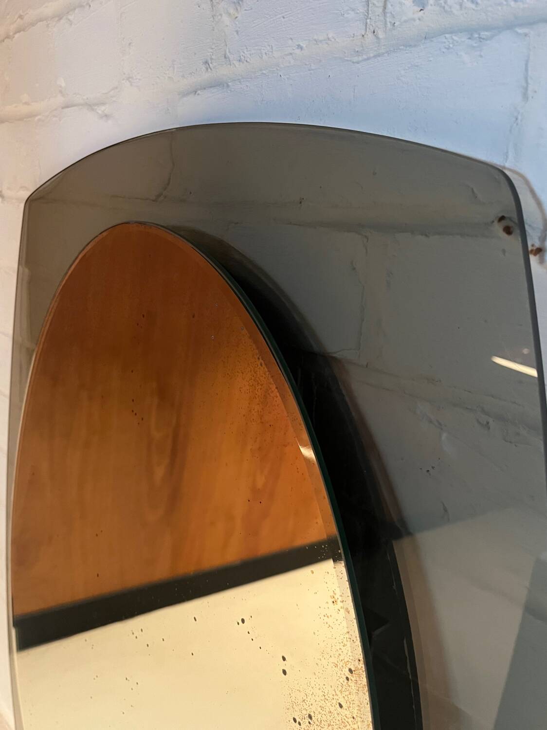 Vintage smoked glass mirror from around 1970.