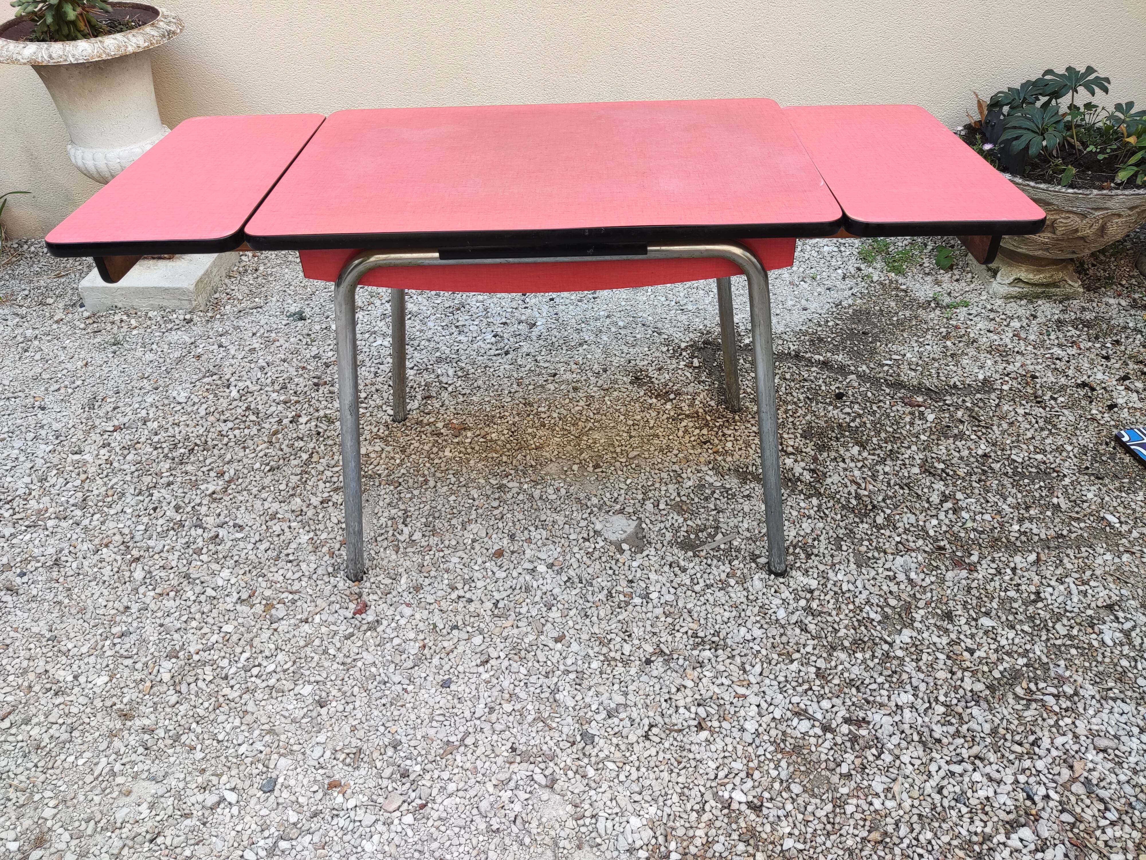 Table with two stools in red formica