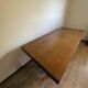 Industrial style table with a mahogany top.