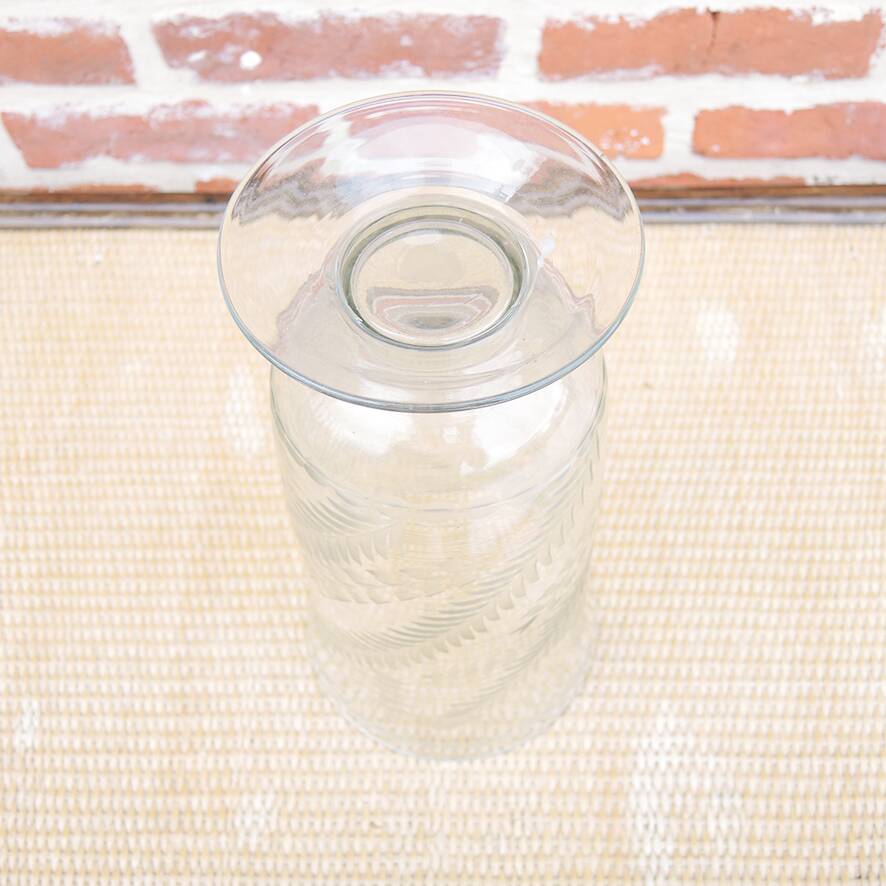 Ancient transparent glass vase with engraved plant decoration.