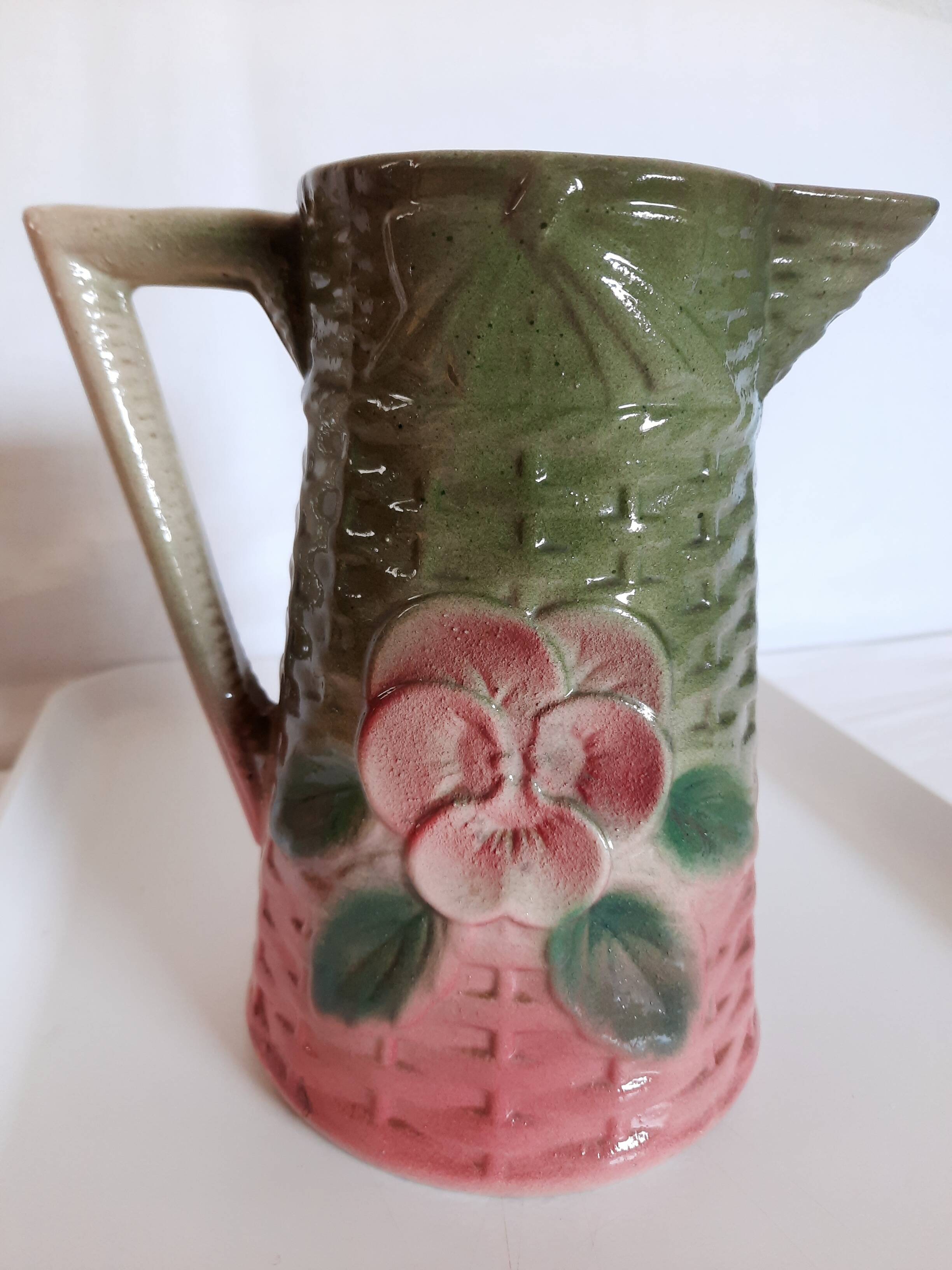 Slush pitcher. Pansy pattern on wicker basket background. Green and pink.