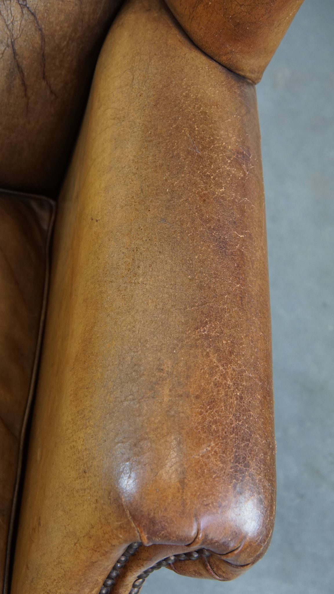 Patinated sheep leather wingback armchair
