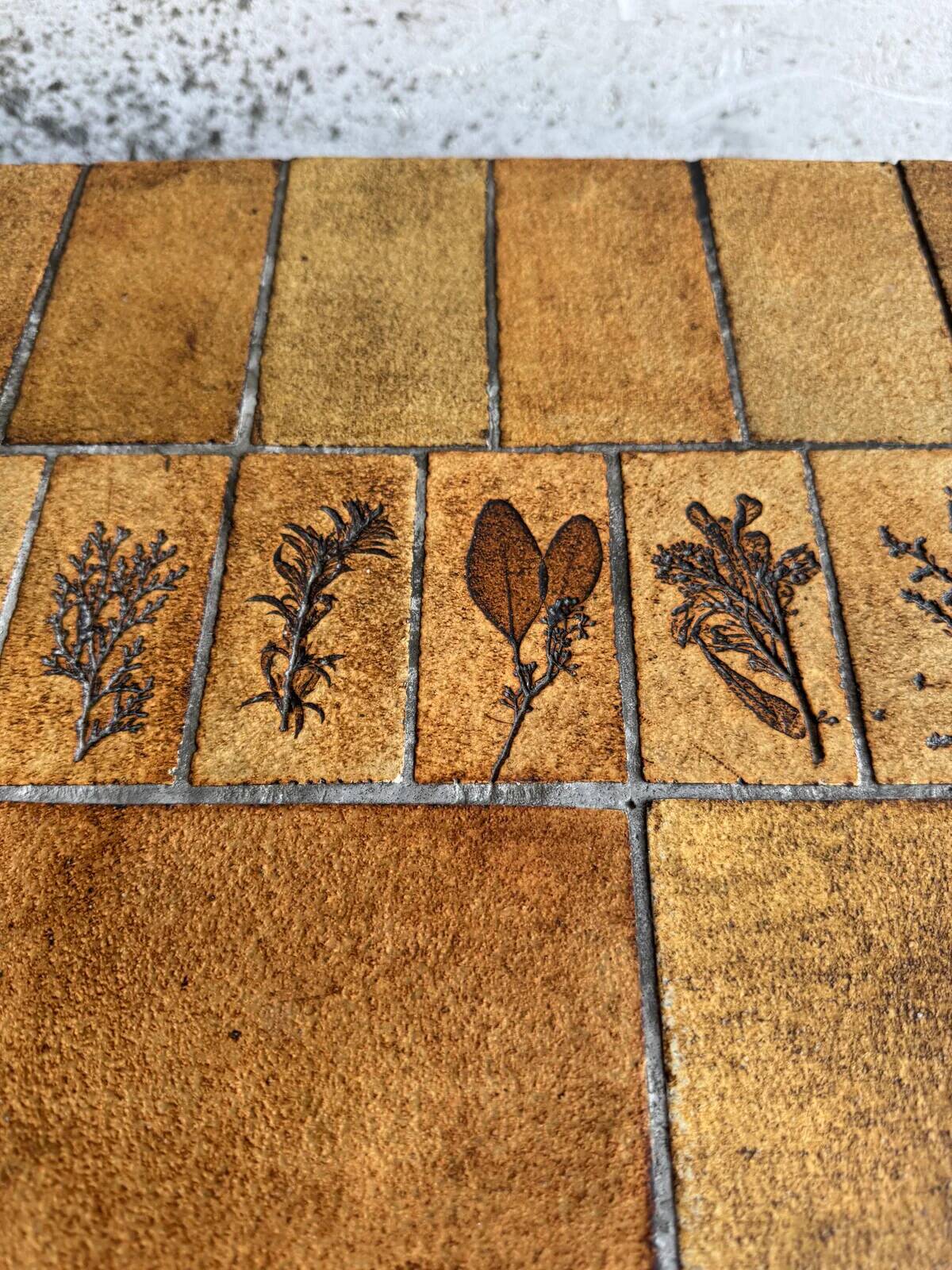 Roger Capron brown-ochre ceramic tile coffee table with wooden base, oval leaf-motif top