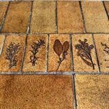 Roger Capron brown-ochre ceramic tile coffee table with wooden base, oval leaf-motif top