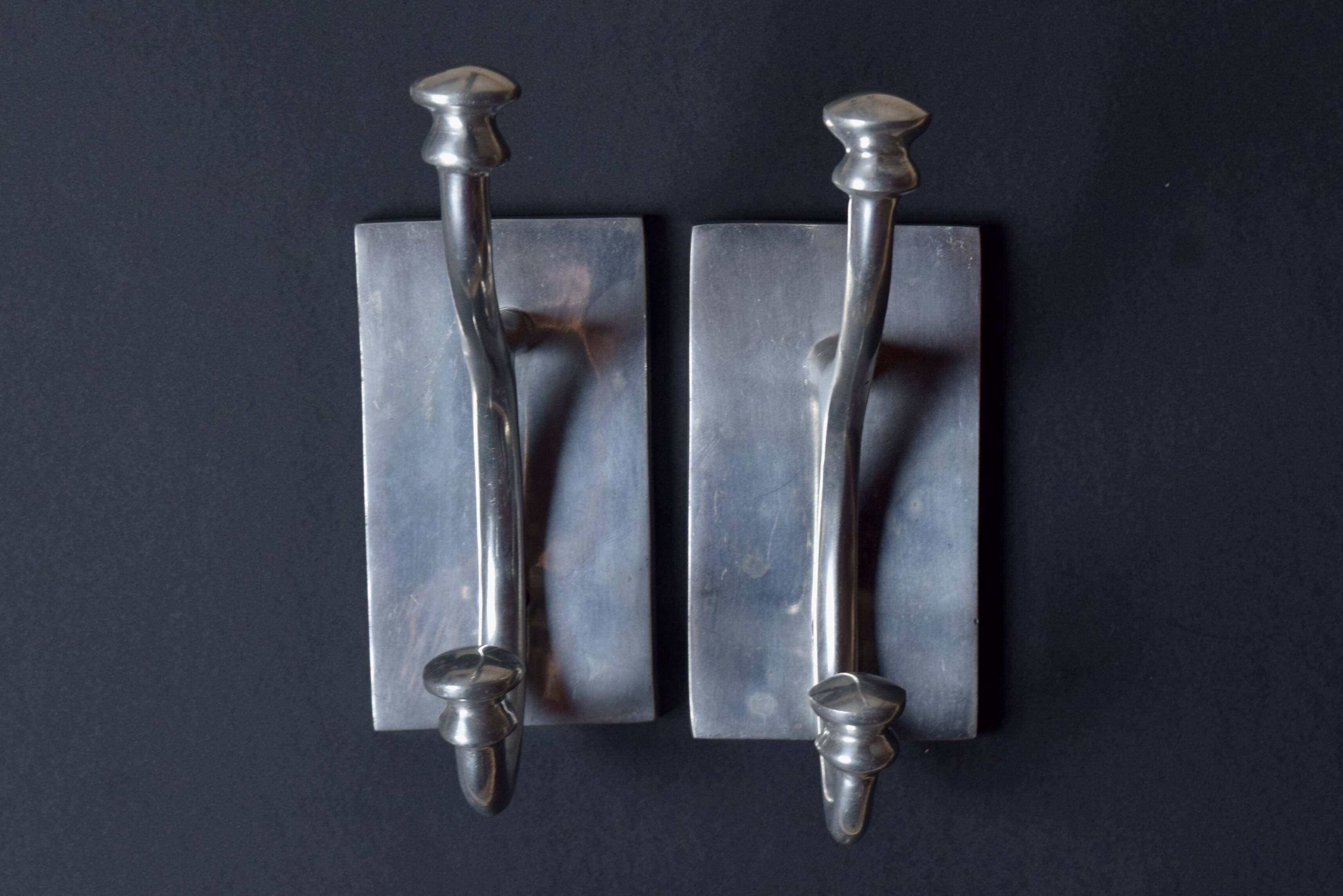 Pair of vintage cast aluminum coat hooks