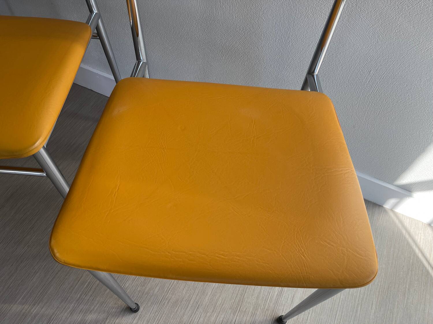 LM vintage chrome and orange/mustard yellow faux leather chairs