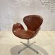 First edition Arne Jacobsen Swan chair, original patinated leather, 1950s
