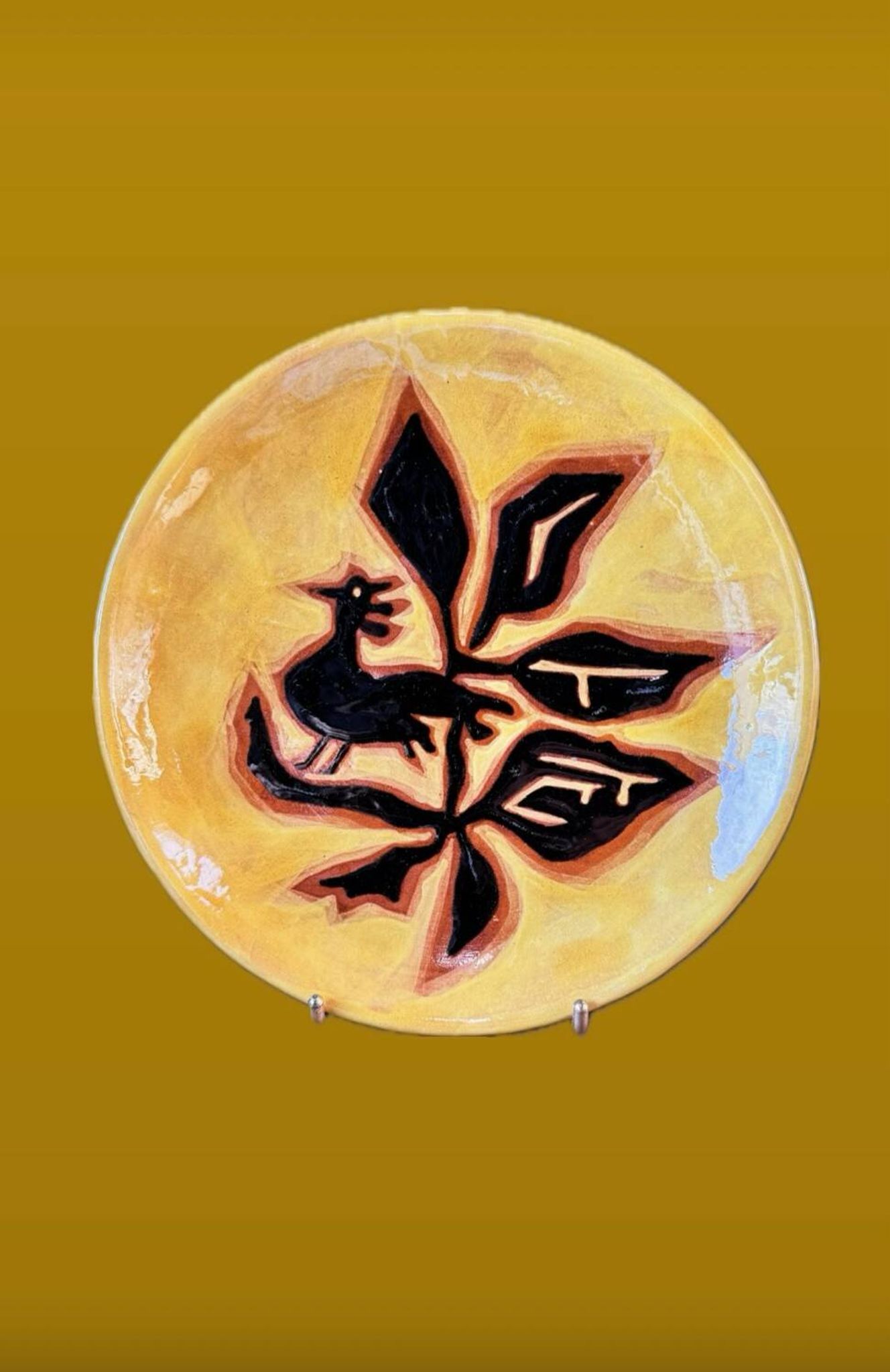 Terracotta plate, Jean Lurçat decorated with a rooster and foliage.
