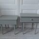Duo of bedside tables, vintage mismatched verdigris end tables.