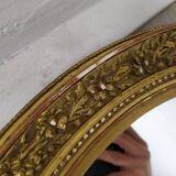 Golden oval mirror