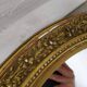 Golden oval mirror